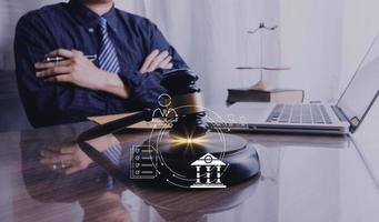 Business and lawyers discussing contract papers with brass scale on desk in office. Law, legal services, advice, justice and law concept picture with film grain effect photo