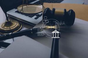 Justice and law concept.Male judge in a courtroom with the gavel, working with, computer and docking keyboard, eyeglasses, on table in morning light photo