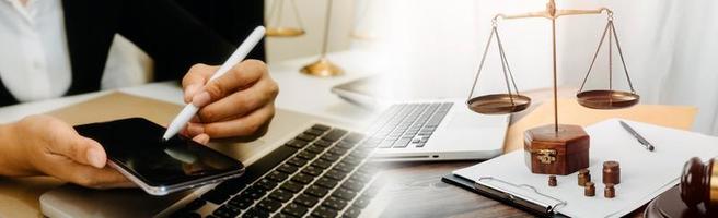 Business and lawyers discussing contract papers with brass scale on desk in office. Law, legal services, advice, justice and law concept picture with film grain effect photo