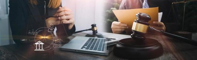 Business and lawyers discussing contract papers with brass scale on desk in office. Law, legal services, advice, justice and law concept picture with film grain effect photo