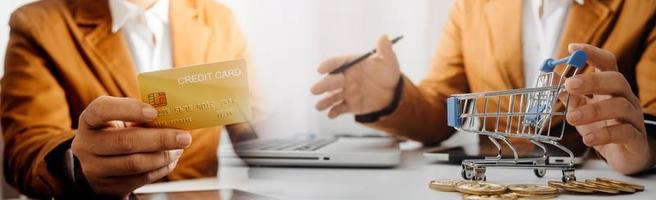 technology, people and online shopping concept - happy smiling man with tablet pc computer and credit card at home photo