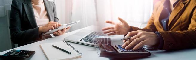 Business accounting concept, Business man using calculator with computer laptop, budget and loan paper in office. photo