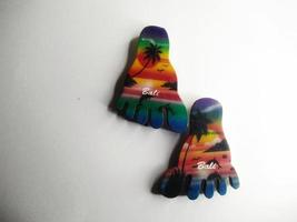Depok, West Java, Indonesia, 2022 - Fridge magnet shaped like feet, hand crafted as souvenir from Bali after vacation. Isolated on white background photo