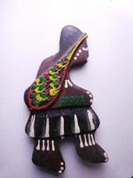 Depok, West Java, Indonesia, 2022 - Fridge magnet shaped like a man from the Asmat tribe in Papua, hand-crafted which he got as a souvenir from Papua after a vacation. Isolated on a white background photo