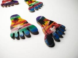 Depok, West Java, Indonesia, 2022 - Fridge magnet shaped like feet, hand crafted as souvenir from Bali after vacation. Isolated on white background photo