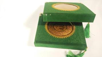 Depok, West Java, Indonesia, 2022 -  Yasin book which is often read by Muslims after prayer. green cover isolated on a white background photo