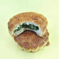 mooncake filled with nuts on yellow background.grilled, delicious, oven photo