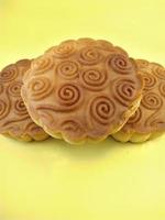 mooncake filled with nuts on yellow background.grilled, delicious, oven photo