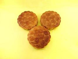 mooncake filled with nuts on yellow background.grilled, delicious, oven photo