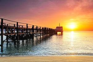 Boat silhouette at sunlight in sea photo