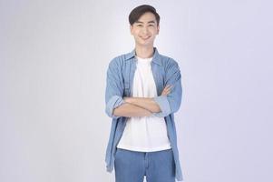 Portrait of young asian man over white background studio. photo