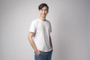 Portrait of young asian man over white background studio. photo