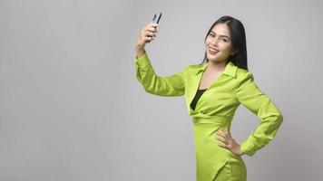 Beautiful woman using smartphone over white background, technology concept. photo