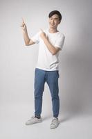 Portrait of young asian man over white background studio. photo