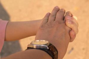 An adult and a child hand holding together. photo