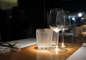 Restaurant table with spotlights ready for dinner guests photo