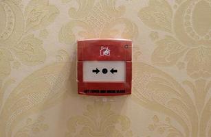 Fire alarm mounted on a wall in a hotel photo