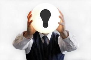 Man holding lightbulb - ideas and creativity photo