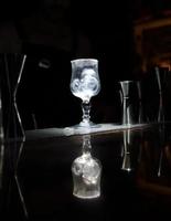 Preparing a cocktail - glass with ice cubes and sugar coating in a cocktail bar photo