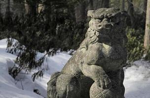 Stone creature in the forest surrounding a shrine in Kusatsu Onsen, Japan photo