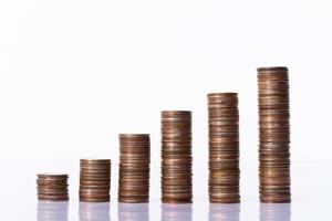 Stack of six coin column as money saving investment or wealth grow and get profit from time. Economy success make money earning as graph growth over white background isolated photo