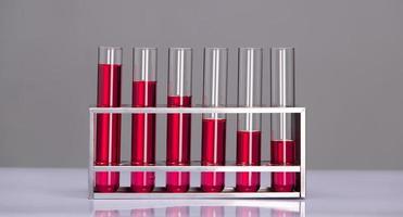 Lab tubes Growth Concept. Several glass tubes on rack with increasing amount of liquid in consecutive tube. Metaphor compare as Science investment research and development bar chart photo