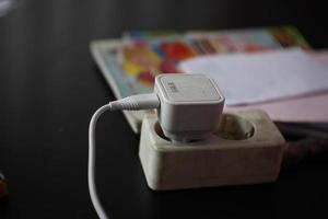 Smartphone charger that is still in use. photo