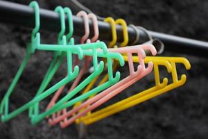 Plastic clothes hanger on an old light gray iron. photo