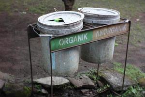 2 trash cans that have been damaged and are still in use. photo