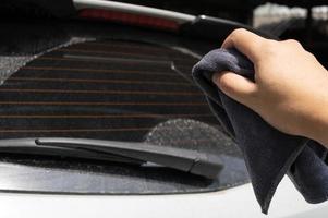 microfiber cloth with hand preparing to wash a car. Car wash concept. Selective focus. photo