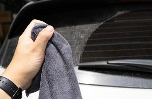 microfiber cloth with hand preparing to wash a car. Car wash concept. Selective focus. photo