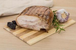 Turkey roll on wooden board and wooden background photo