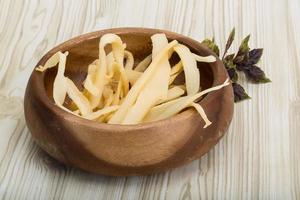 Dry calamari in a bowl on wooden background photo