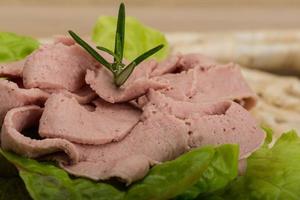 Liver pate on wooden background photo