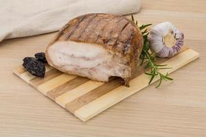 Turkey roll on wooden board and wooden background photo