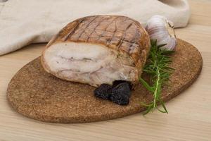 Turkey roll on wooden board and wooden background photo