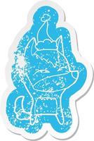 cartoon distressed sticker of a wolf whistling wearing santa hat vector