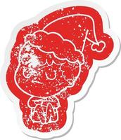 cartoon distressed sticker of a grumpy boy wearing santa hat vector