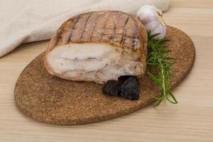 Turkey roll on wooden board and wooden background photo