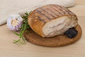 Turkey roll on wooden board and wooden background photo