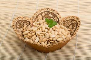 Peanut in a basket on wooden background photo