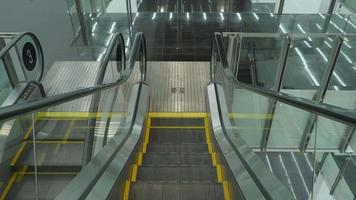 Close up shot of empty moving staircase running up and down. video