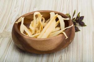 Dry calamari in a bowl on wooden background photo