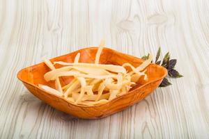 Dry calamari in a bowl on wooden background photo