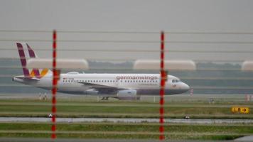 DUSSELDORF, GERMANY JULY 24, 2017 - Germanwings Airbus a319 D AKNV taxiing after landing at rain, cross runway. Dusseldorf Airport video