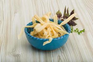 Dried squids in a bowl on wooden background photo