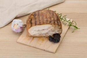 Turkey roll on wooden board and wooden background photo