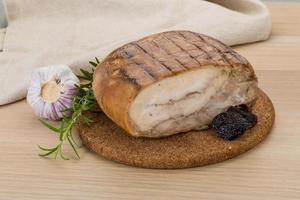 Turkey roll on wooden board and wooden background photo