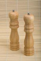 Pepper mill on wooden background photo