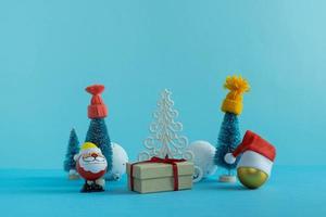 Santa Claus and Christmas trees in winter hats with gifts. Merry Christmas. Happy New Year photo